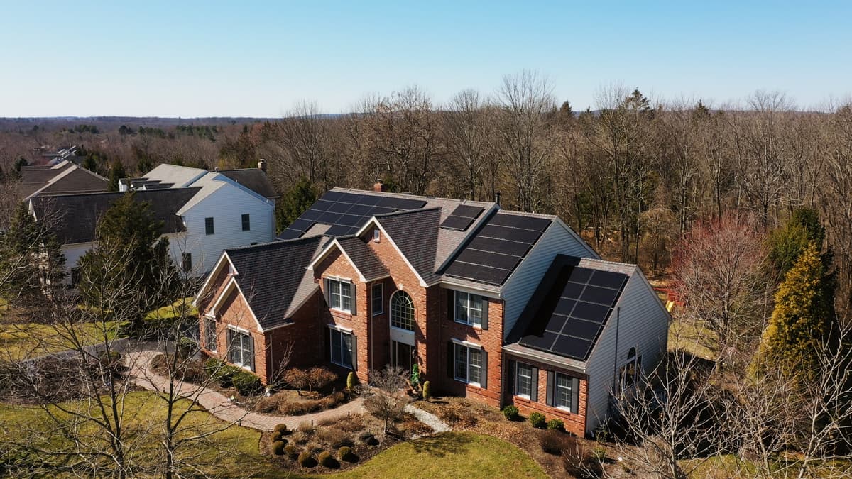 Professional solar installation - aerial view of brick house